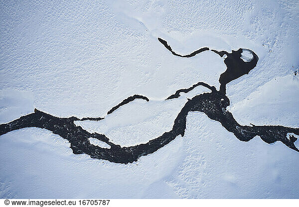 Frozen river in mountainous area in winter