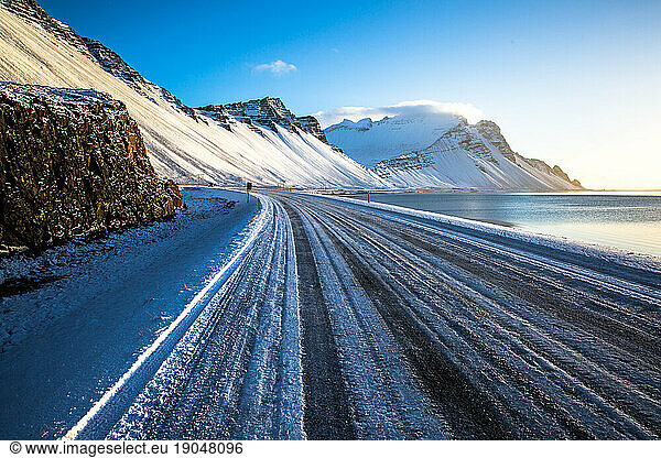 Frozen road in Iceland with mountains in the background