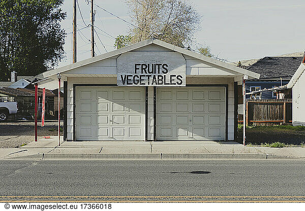 Fruits and Vegetables sign and a closed market stall on a small town street