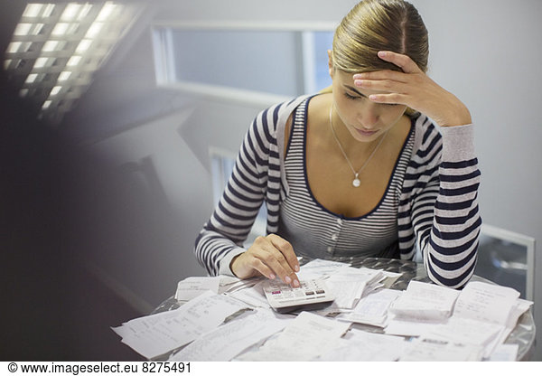 Frustrated woman paying bills