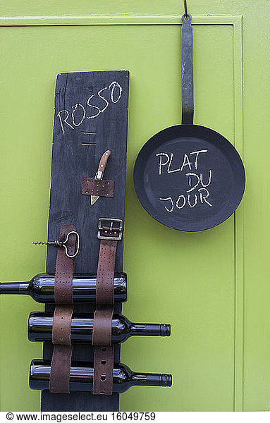 Frying pan and DIY wine rack made of wooden plank and old belts
