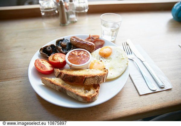 Full English breakfast on counter in cafe