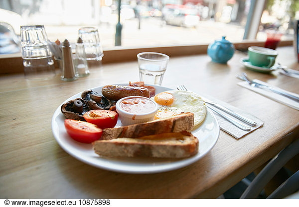 Full English breakfast on window seat counter in cafe