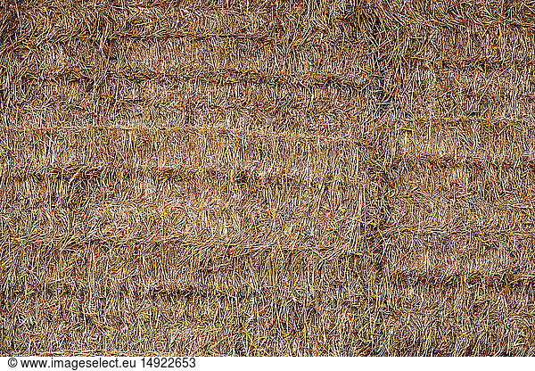 Full frame close up of neatly stacked straw bales.