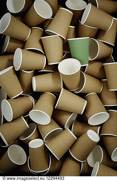 Full frame green recyclable coffee cup among disposable cups