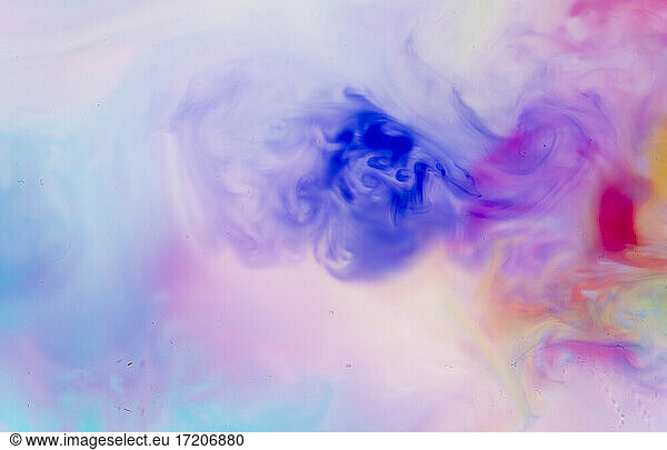 Full frame of blue  purple and red liquids mixing together