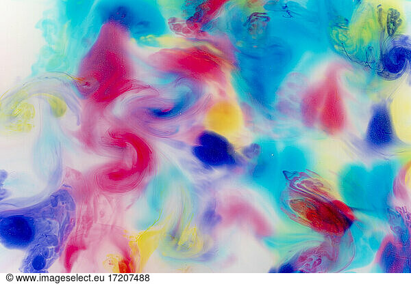 Full frame of colorful liquids mixing together