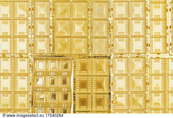Full frame of gold colored plastic packaging