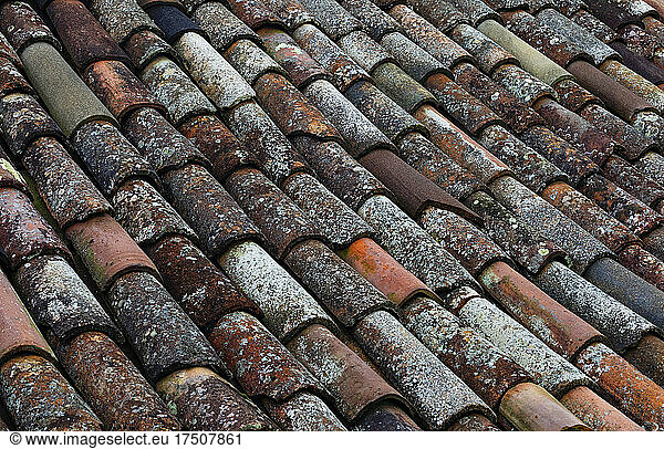 Full frame of weathered tiles of old roof