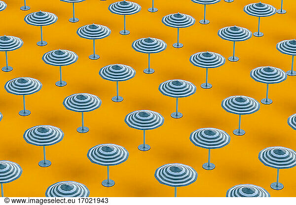 Full frame shot of beach umbrellas on orange background