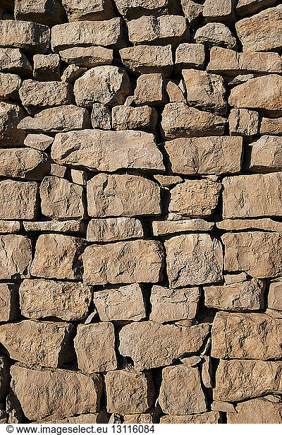 Full frame shot of stone wall on sunny day