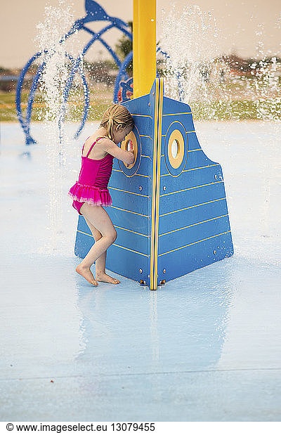 Full length of girl in swimwear enjoying at water park