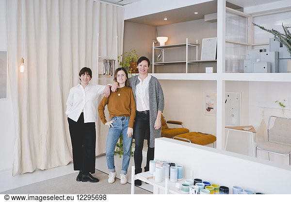 Full length portrait of female interior designers standing in store