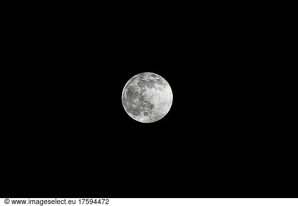 Full moon glowing against clear sky at night