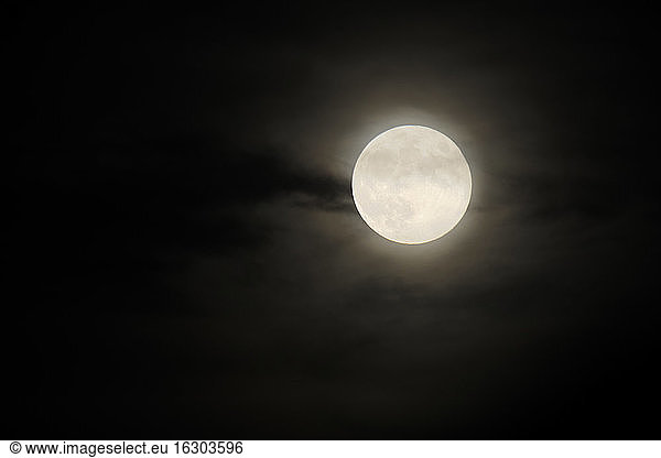 Full moon glowing against night sky