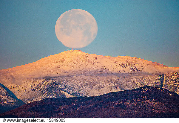 Full moon sets over New Hampshire's Mt. Washington