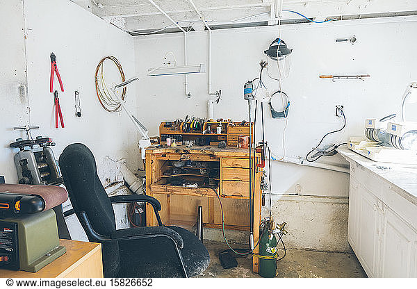 Full show of bright home studio with workbench assorted tools and more
