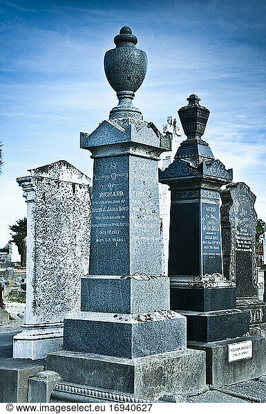 Funeral monuments and headstones in cemetery.
