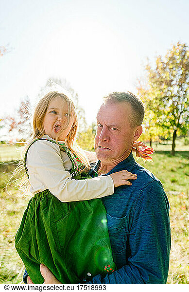 Funny portrait of a father and daughter making silly faces