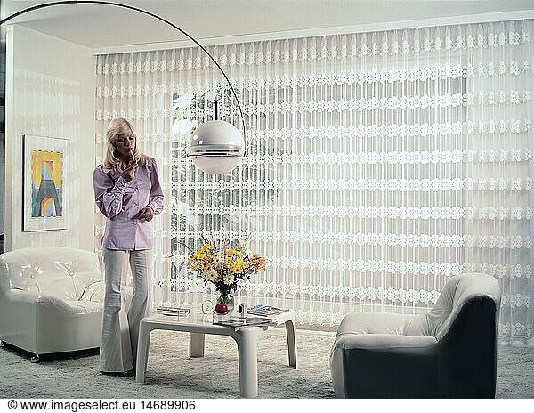 furnishings  woman lighting a cigarette in the living-room  1970s