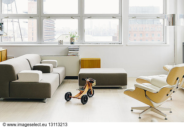 Furniture on hardwood floor against windows in startup office