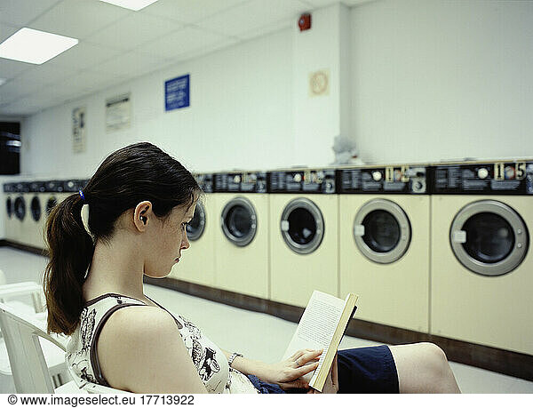 Fv3700  Huy Lam; Woman Reads Book In Laundromat