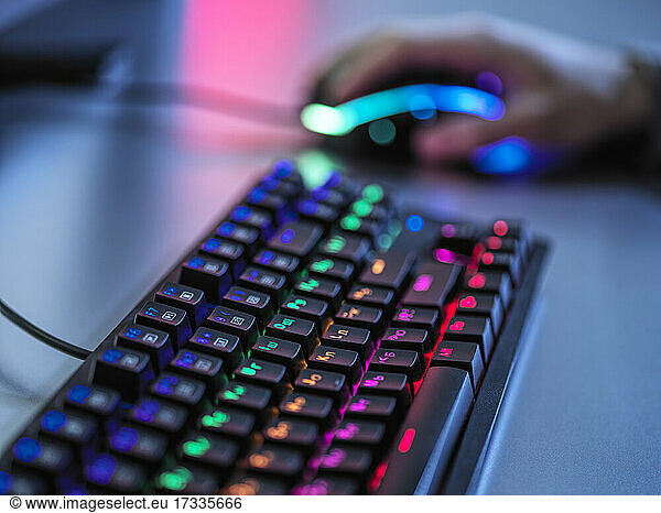 Gaming keyboard with illuminated keypad on table