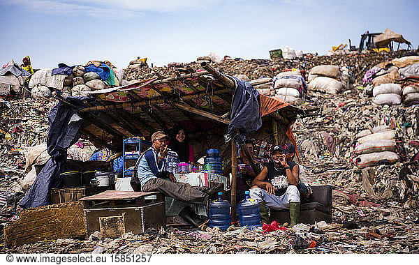 Garbage collectors take a rest in a small shelter built by themselves