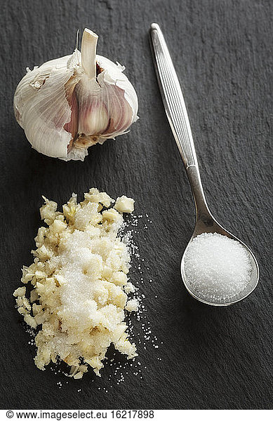 Garlic with salt in spoon  close up