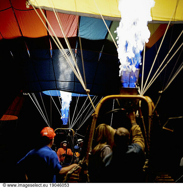 Gas burners inflating two hot air balloons.