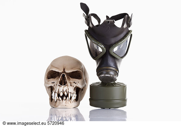 Gas mask and vampire skull on white background