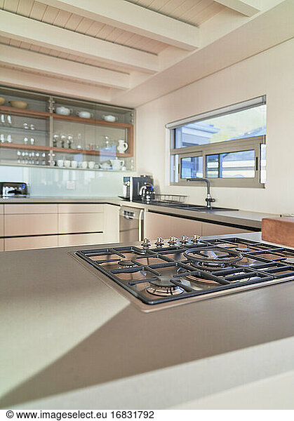 Gas stovetop on sunny counter of home showcase interior kitchen