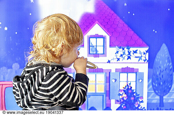 Gaspard Launay watching a cartoon on television.