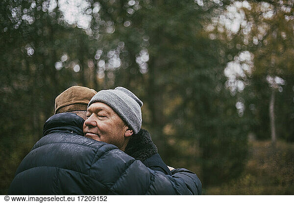 Gay couple embracing each other in forest