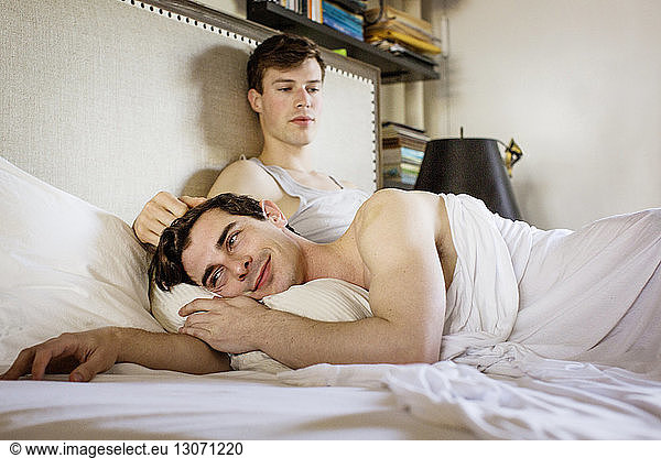Gay couple in bed at home