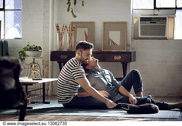 Gay couple relaxing at home