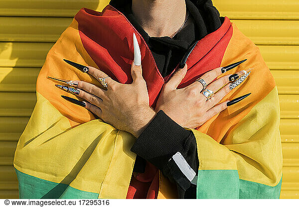 Gay man wrapped in rainbow flag
