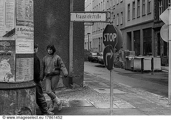 GDR  Berlin  05. 03. 1988  Krausnickstraße  corner of Große Hamburger Straße  conversation at the advertising pillar