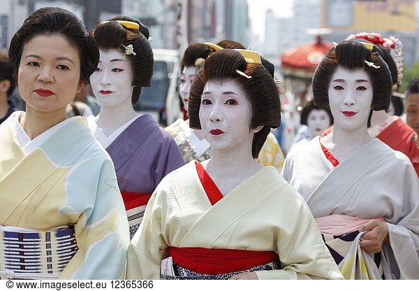 Geishas walk towards Sensoji Temple during the Daigyoretsu or Large Parade of Sanja Matsuri Festival in Asakusa on May 18  2018  Tokyo  Japan. The Daigyoretsu Parade is a large procession of priest  city officials  musicians  geishas and dancers dressing Edo Period costumes through Asakusa streets until Sensoji Temple. This is one of the Three Great Shinto Festivals in Tokyo  that is held on the third weekend of May.