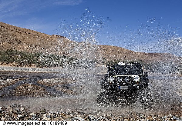 Geländewagen durchquert einen Fluss im mittleren Atlas  Marokko  Afrika