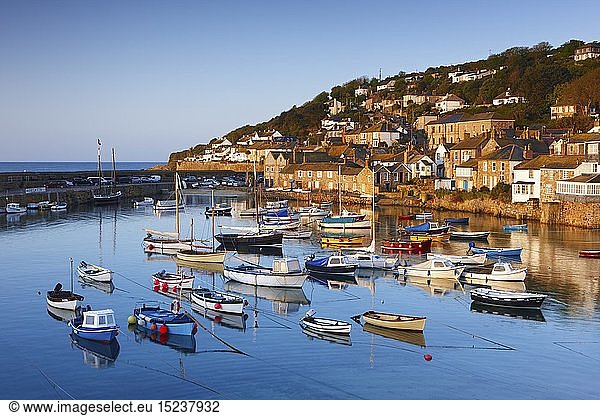 Geography / travel  Great Britain  England  Cornwall  The first light of dawn catching the cottages along the waterfront  overlooking the picturesque Cornish Harbour of Mousehole.