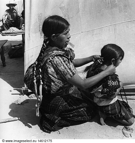 geography / travel  Guatemala  people  women with children  women is binding pigtail  circa 1960