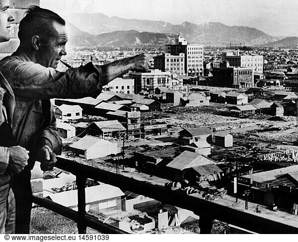 geography / travel  Japan  Hiroshima  city views / cityscapes  rebuilding  August 1947  historic  historical  Asia  20th century  1940s  atomic bombing  house building  houses  construction  reconstruction  misery  adversity  WWII  Second World War  1945  man  American  showing  pointing  people  men  male
