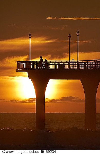 geography / travel  New Zealand  South Island  Canterbury  Christchurch  New Brighton Pier  dawn  silhouette  colour  orange  people