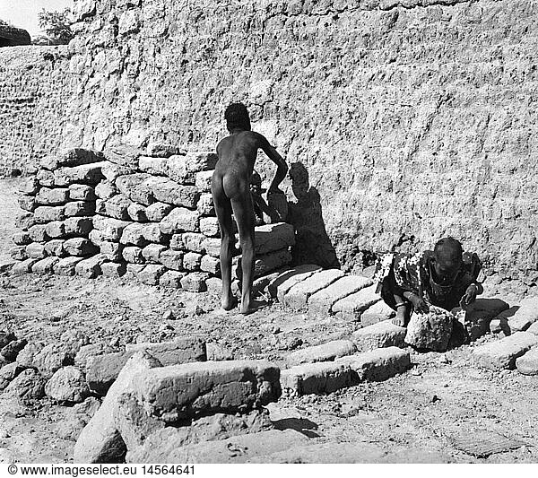 geography / travel  South Africa  people  two native people making clay bricks  circa 1950s