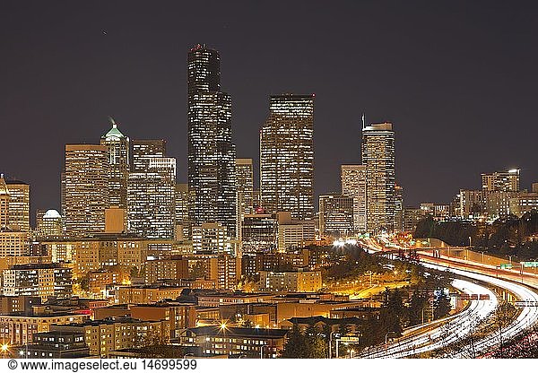 geography / travel  USA  Washington State  Seattle  Night skyline of the city of Seattle at dusk in Washington State  with flowing traffic on the highway.