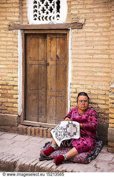 geography / travel  Uzbekistan  Khiva  historic old town  woman embroidering