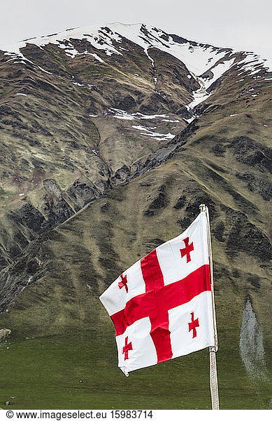 Georgia  Svaneti  Ushguli  Low angle view of Georgian national flag fluttering against mountain