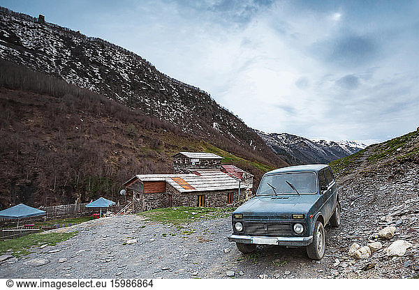 Georgia  Svaneti  Ushguli  Old car parked in front of house in medieval mountain village