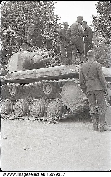German soldiers and a Soviet tank KV-1. Zhovkva (??????)  Lviv region  Ukraine  USSR. Summer 1941.